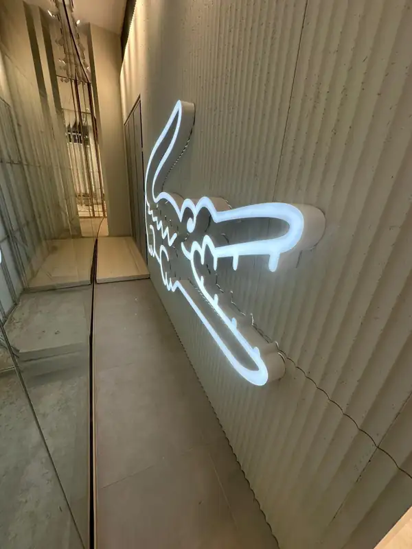 Face-lit illuminated logo, fashion retail store, Europe