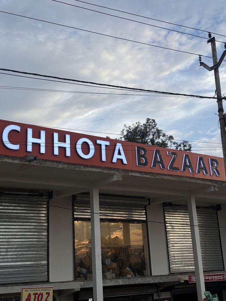 Red and white 3D letter signboard above a retail shopfront in India, made by ALFA Signage