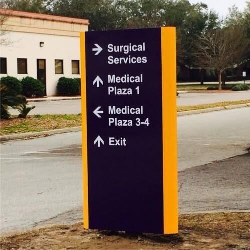Outdoor directional wayfinding pylon sign with arrows for medical services, made by ALFA Signage
